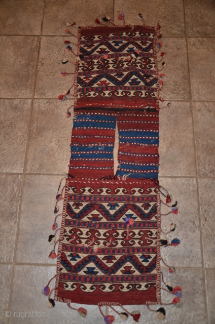 Western anatolian heybe, Kilaz, farda (kilim) technique. 4 ft. 2 in. X 1 ft. 2-1/2 in. Circa 1900. Wool. Probably a dowry/bridal piece with intact pompom tassels. Very good condition - slight  ...