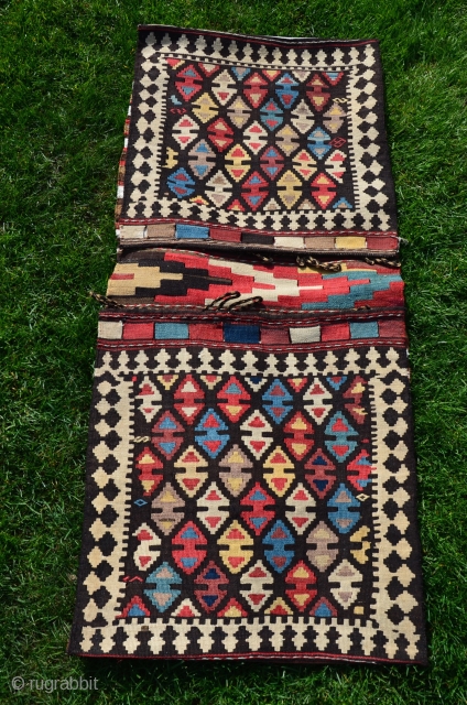 Shahsavan flat woven (kilim) khorjin with decorated bridge. 1'10" x 4'1". Circa 1900. Wool. Some faded fuchsin in a few motifs testifies to age. Otherwise all saturated natural dyes. Clean and in  ...