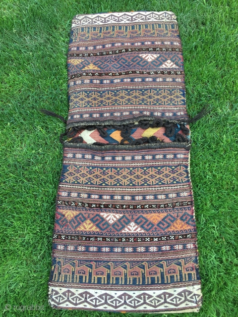 Baluch flat woven khorjin with camel train decoration. 48-1/2" X 19". First 1/3 20th C. Wool. Weft substitution weave in face. Plainwoven white back. Decorated bridge. Intact closure loops. Excellent condition.  