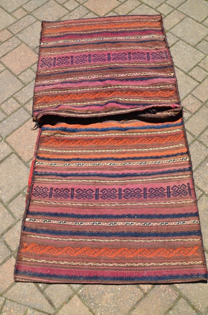 Large Baluch flat woven khorjin, 2nd. Q. 20th C. 64" X 34". Wool. Weft substitution designs on face, plain woven striped back. goathair fastening loops and edge wrapping intact. Excellent condition. No  ...
