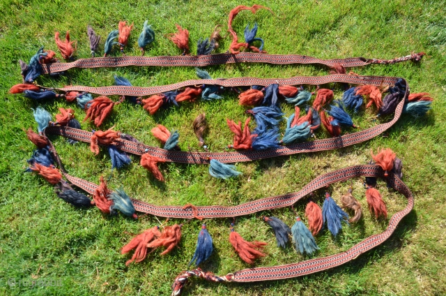 Yüncü Yörük band with tassels, locks of human hair and glass beads. 21 ft. X 1-3/4 in. Wool, Cardwoven, warp faced. Natural dyes. Early 20th C. According to input from a knowledgeable  ...