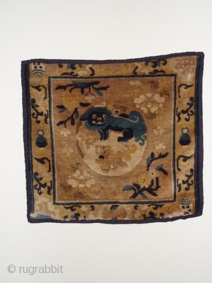This Ningxia mat is a great example of late 18th-early 19th century Ningxia Chinese rug weaving. The central Yin Yang Fu Lion image is surrounded by peach and chrysanthemum blossoms and the  ...