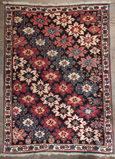 small Kuba rug with great natural color and a repeat star or snonwflake design on an oxidized dark ground giving a fantastic sculptural effect. 2'10"x3'10"        