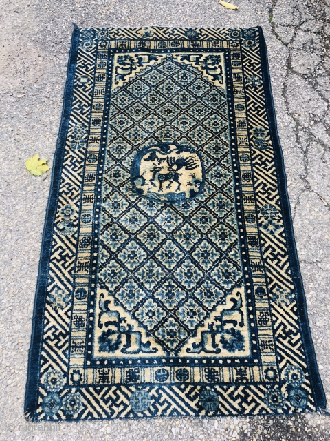 Antique Chinese rug measuring 54" * 30"
Ends missing, one small hole and small areas of wear                 