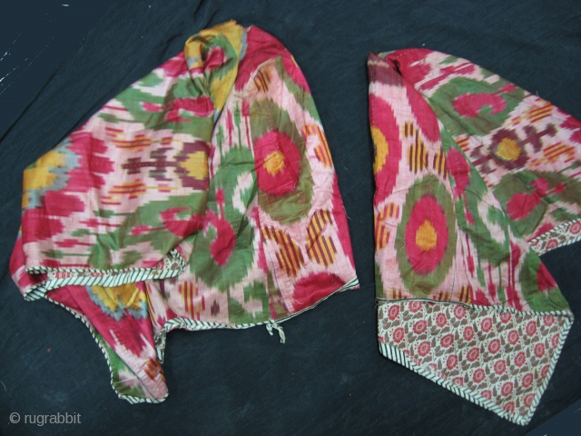 A matching pair of  Antique Uzbek silk Ikat craddle covers. Very good condition. Both pieces have a hole for the stick.           