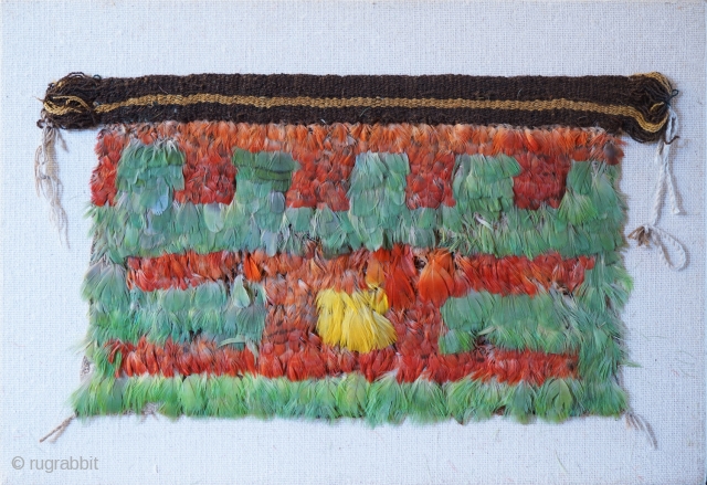 Pre-Columbian miniature feather mantle from Nasca. Presumed to be the mantle for a doll of grave goods.
20cm x 36cm              