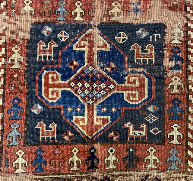 Kurdish Long Rug, 3’11 x 9’10 / 119 x 300 cm., Field divided
into four sections, each section contains a quatrefoil medallion
surrounded by small animals, angular “S” -shaped and reciprocal
floral sprays in borders 