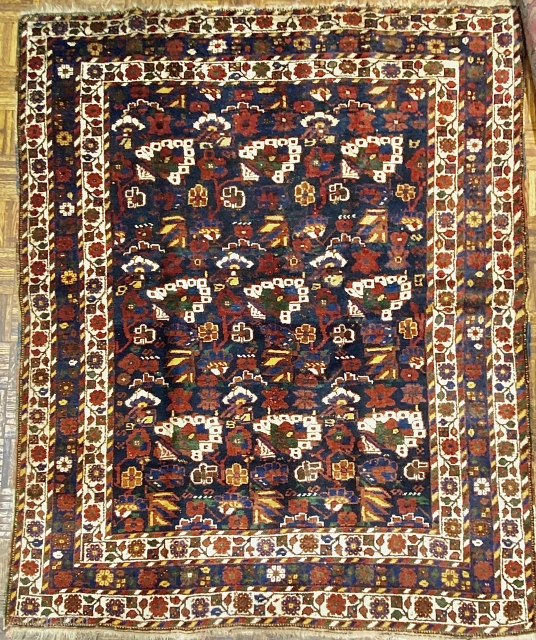 Small Afshar Carpet, 5’3” x 6’6” / 169 x 198 cm.
Floral pattern in field, on indigo ground; white ground 
secondary borders, indigo ground central border 
Good pile.      