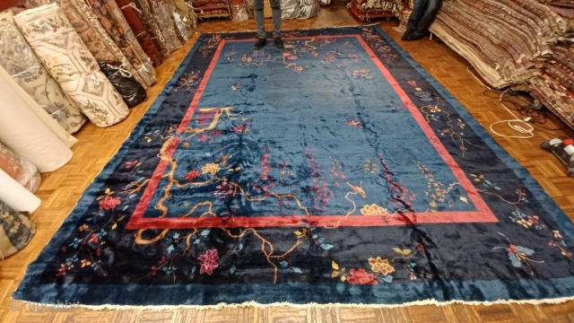 Chinese carpet, ca. 1900; 9’11 x 13’2” / 302 x 401 cm. 

Exceptionally glossy wool with hand-spun warps, flowering gnarled trees with butterflies and birds in field, medium blue 

ground, solid red  ...