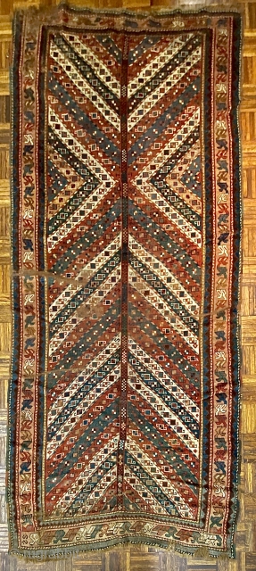 NWP Long Rug, ca. 1850; 4’2” x 9’4” / 127 x 284 cm

Field composed of brightly colored, diagonal stripes converging at central trunk or stem.

possibly an abstracted tree. Stripes in madder red,  ...