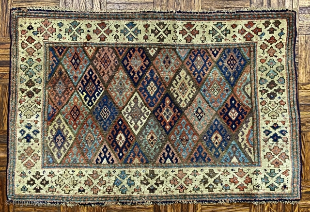 Jaf Kurd Bagface, ca. 1880; 2’x 3’ / 61 x 91 cm

Lattice of diamonds in , each inhabited by a hooked diamond totem with

small animal heads.  Main border on ivory, geometric  ...