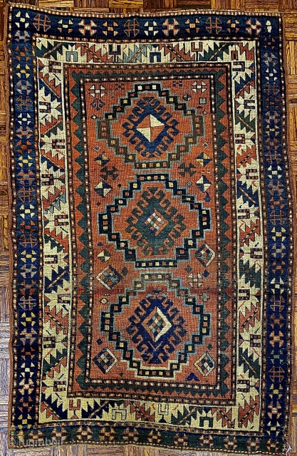 Antique Kazak Rug, ca.1880; 4’1” x 6’4” / 124 x 193 cm

Three medallions, loosely diamond shaped, with hooked diamond centers, populate 

the dark salmon pink  field, surrounded by a sawtooth border  ...