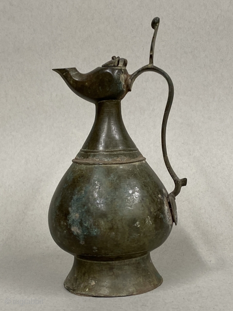 Seljuk Bronze Ewer, ca. 12th Century CE;

Diameter:  4 3/8” // 11.1 cm

Height - including crest:  9 5/8” // 24.4 cm

Diameter Base: 3 5/8” // 9.2 cm

Antique, gracefully pear-shaped ancient bronze  ...