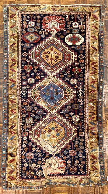 Antique Shirvan Karagashli Caucasian rug, ca. 1870; 4’ x 7’ / 122 x 213 cm

Three multicolored hexagonal diamond medallions and red-palmette finials set

on a deep indigo field. Multitudinous totemic emblems resembling flower-heads

surround  ...