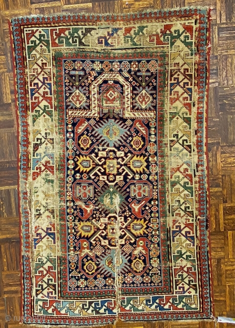 Bidjov Kuba Caucasian prayer rug m, ca. 1880; 3’6” x 5’4” / 106.7 x 163 cm

Indigo field with numerous totemic creatures, and stylized flowers.  Mihrab 

arch woven in ivory white. Trefoil  ...