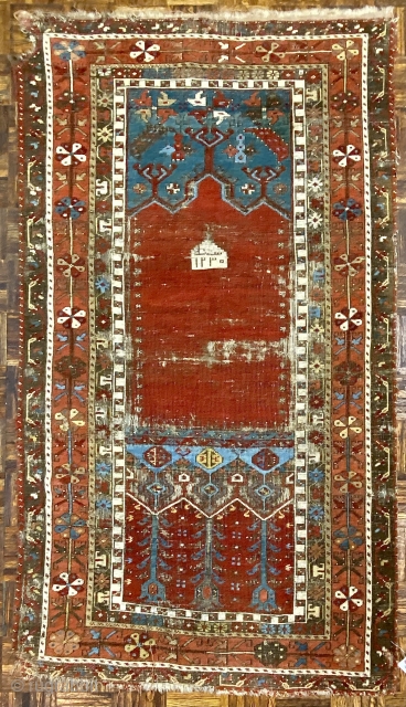 Antique Ladik Prayer rug, dated A.H. 1230 ( 1815 CE); 3’7” x 6’5”

Woven a relatively long vertical shape, this Ladik features the classic

arrangement of a red, triple-arch mihrab set above a panel  ...