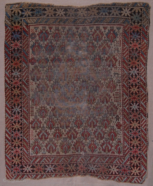 Caucasian Shirvan rug fragment. Probably not the rarest type of Shirvan rugs. It has some worn areas in the field. Otherwise has great colors and now being sewn onto linen support, conserved,  ...