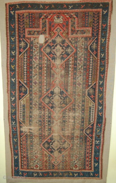 Karabakh prayer rug. It has a design of thin, vertical, multi-coloured stripes. The stripes are filled with tiny motifs linked together. In the axis of the mihrab three diamond-shaped medallions. If I  ...