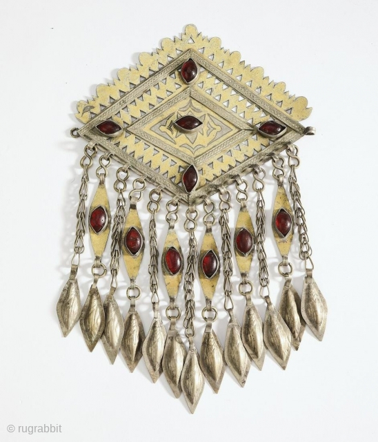 Tekke Turkmen robe closure pendant, late 19th or early 20th century. Lozenge form with piercing and engraving as well as chasing of gold over silver, with cabochon set glass, suspending chains with  ...