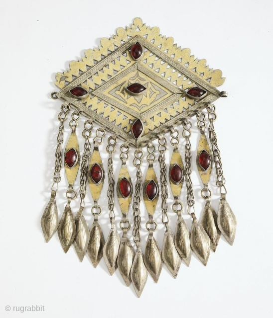 Tekke Turkmen robe closure pendant, late 19th or early 20th century. Lozenge form with piercing and engraving as well as chasing of gold over silver, with cabochon set glass, suspending chains with  ...