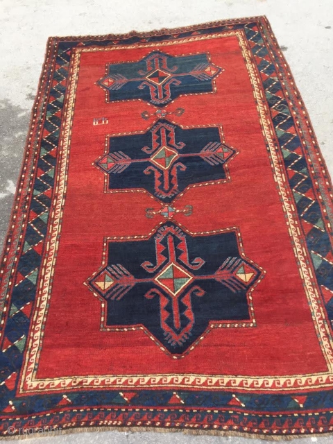 Antique Kazak rug. Beautiful open field with great greens and light blues. Good medium pile throughout. Dated. One old repair which is barely visible from the front.

Cheers.      