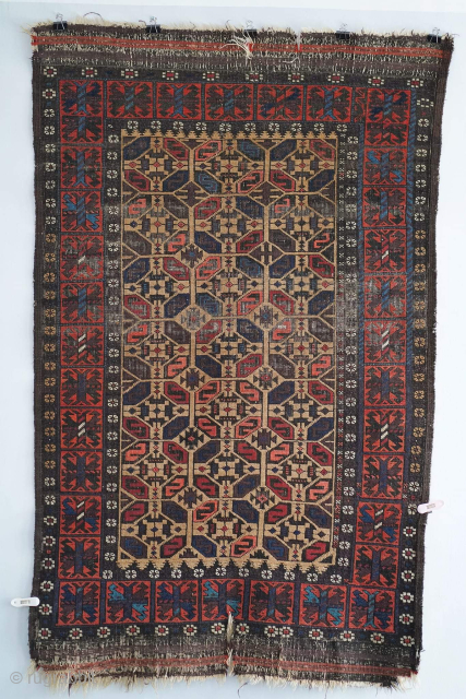 Antique "S" gul Baluch rug with camel hair field. It's a striking piece. It has a few small tears at the ends, visible. Other than that it has no repairs.

Please contact me  ...