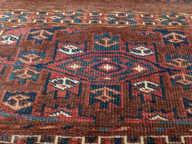 19th Century Yomud torba. 1'5" x 3'9" or 43 x 114cm. Typical dark purplish brown field. No repairs and even low pile with shiny wool. Nice polychromatic blue and good greens.

Cheers.  