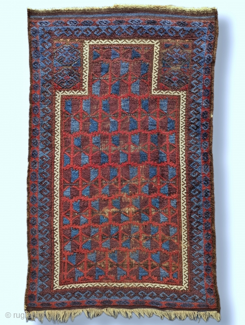 Antique Baluch prayer rug with an unusual amount of glowing blue. There's a nice aubergine with fluffy wool and a loose handle. Contact me at: steven.malloch@gmail.com or gerrerugs@gmail.com     