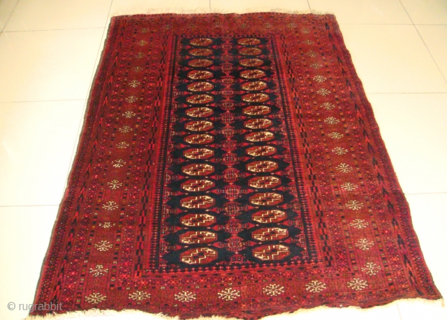 Original, Early 20thC. Afghan Turkmen "Blue" Bokhara. (It is neither of Baluch nor of Pakistani provenance.)
As described by J.K. Mumford in his book "Oriental Rugs" (Bramhall House 1981 edition): "Very rarely a  ...