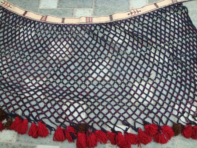 Late 19thCentury, "Saryk" Turkmen tent trapping from N.W. Persia. White Cotton band with Woolen mesh (black) sewn to one side. Woolen baubles knotted to the ends of the mesh. Used for decoration  ...