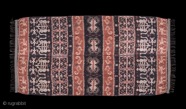 Hinggi Kombu, Sumba , Indonesia. Prior 1950.

Man's ceremonial shoulder wrap, cotton, decorated with warp ikat used for adat exchanges and clothing.
Alternating rows of terracotta and dark brown bands with gryphons, birds, monkeys,  ...