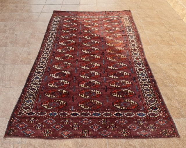 Ex-Azadi Yomud group main carpet. Early 19th century. Size is 265 x 163. Some consistent with age wear and repairs in the field as shown. With original Azadi label on backside (picture  ...