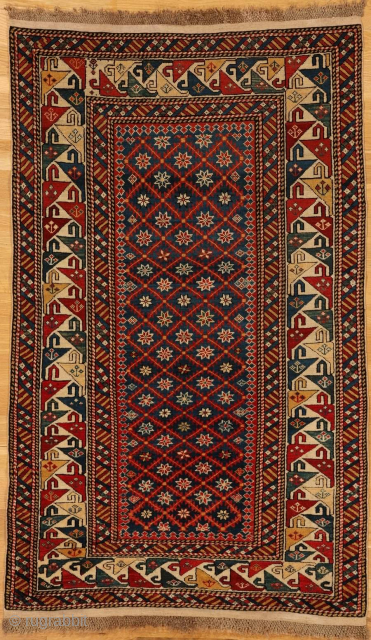 Shirvan rug from eastern Caucasus,west coast of the Caspian Sea

Age: circa 1875

Size: 5′.3″x3′.3″ (160×99 cm)

The royal blue field shows a small lozenge lattice enclosing eight pointed stars in ivory,red,blue,yellow and black.At the  ...
