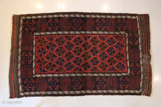 Ca.1920 Baluch Rug. 180 x 104 cm. The subtle Gul designs on the dark border contrast with the vibrant soft red pile of the field.
https://hakiemieruggallery.com/        