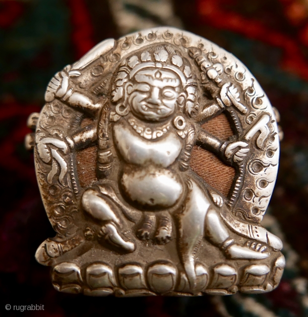 18th c. Tibetan Buddhist Silver Bhairava 'Gau' depicting Bhairava(Mahakala),  a fierce deity protector of Buddhist dharma;  copper backing,  efficacious for contact with the bare skin of the traveling lama;  ...