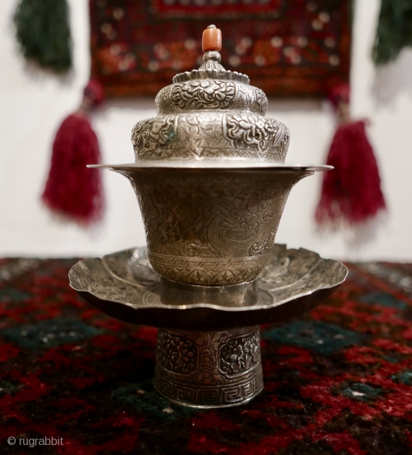 18th-19th c Tibetan silver teacup holder (dkar yol yu),  lid (kha leb)and cup (phor pa) with very finely chased and repousse-worked Buddhist auspicious symbols and a splayed lotus fineal surmounted by  ...