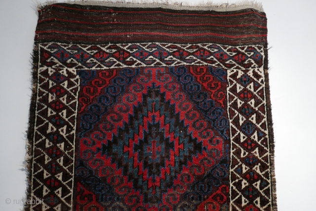 Mushwani Belouch/Baluch,  circa 1900,  2'10"x5'6",  wild and beautiful, with vivid red,  blue,  aubergine and white;  symmetrically knotted; kilim ends are complete except for small rough spot  ...