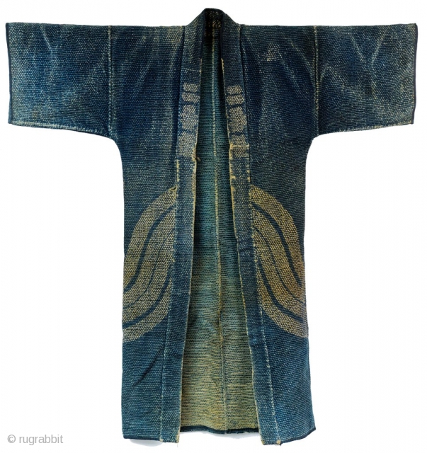 Heavy weight, densely stitched indigo dyed cotton. Tsutsugaki dyed cloth. Indigo background with red and white design on the reverse. Horizontal bands wrap around bottom of coat. Similar to reference work "Sumi  ...