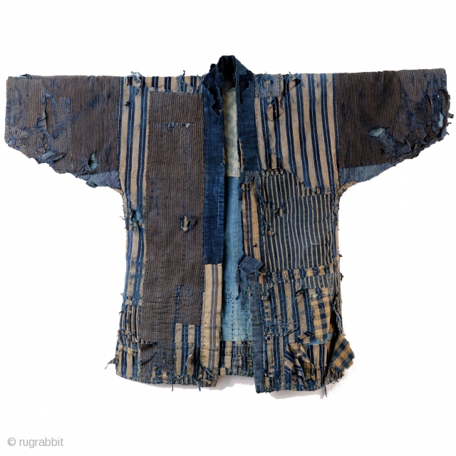 A tattered and stunning Japanese boro work jacket, or noragi. 

Layers of shima striped cottons give way to more stripes. 

Suitable for display or wear, this is one of our favorite jackets  ...