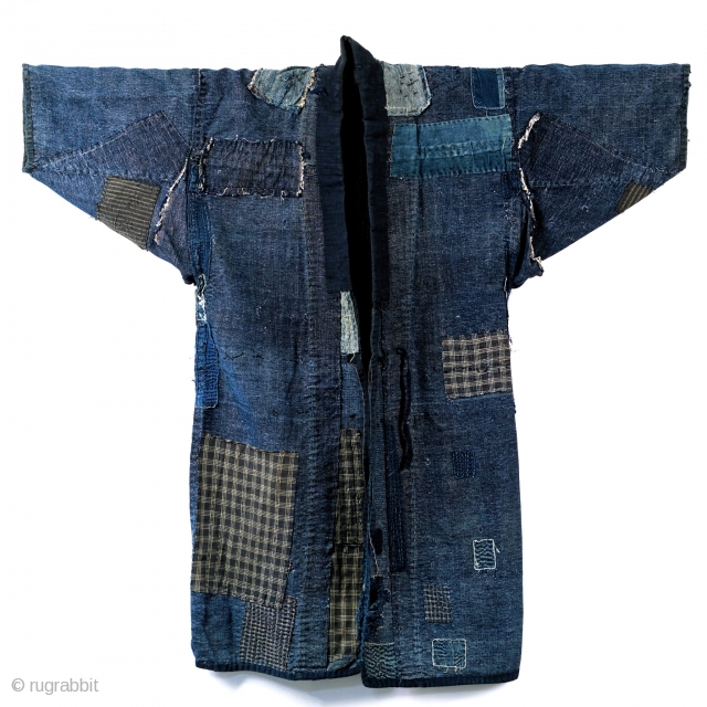 Boro Noragi - Meiji-era Indigo Cotton and Hemp Blend.

Thick, handspun indigo noragi with many mending patches. 

This jacket is heavy and warm and shows many, many years of use, but it still  ...