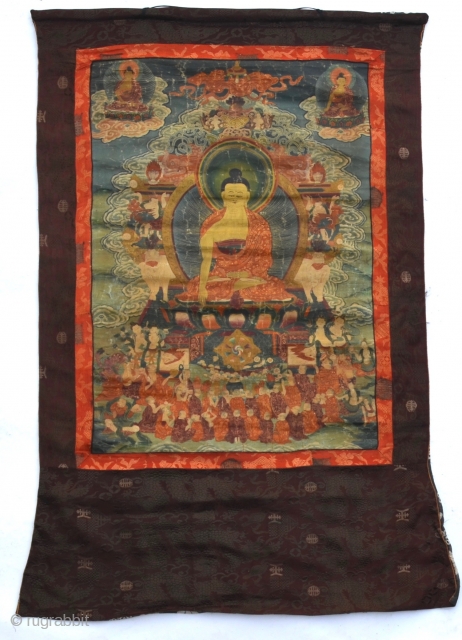 18th Century Thangka Depicting Shakyamuni Buddha, A stunning Tibetan thangka with Shakyamuni Buddha seated atop a lotus throne with hands in bhumisparsa mudra, surrounded by intricate narrative scenes with very fine details,  ...