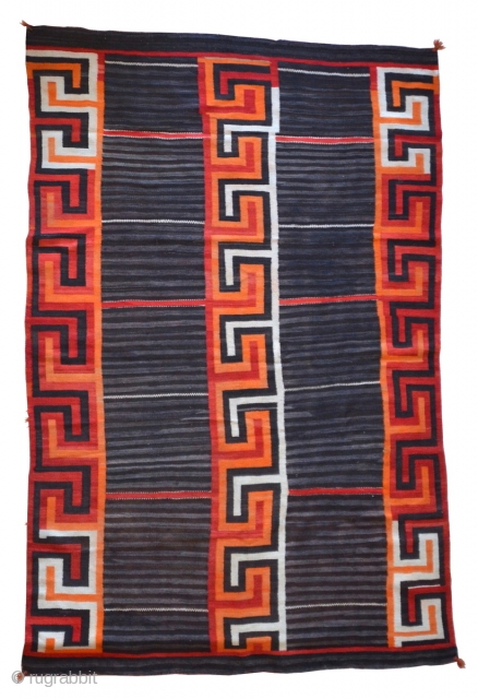 A gorgeous Navajo Transitional blanket (1880-1910) tightly woven in handspun native wool, in natural brown and ivory, indigo and aniline colors, with a variant Chief's design, c1880.

condition excellent

96" x 62"   