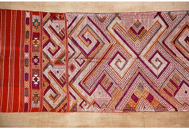 Tai Daeng Xieng Kuang Silk Embroidery
Handwoven and embellished silk on cotton brocade sleeping blanket from Laos. Geometric woven designs with red, purple, green, gold, and ivory brocade. 

74" L x 27.5" W  ...