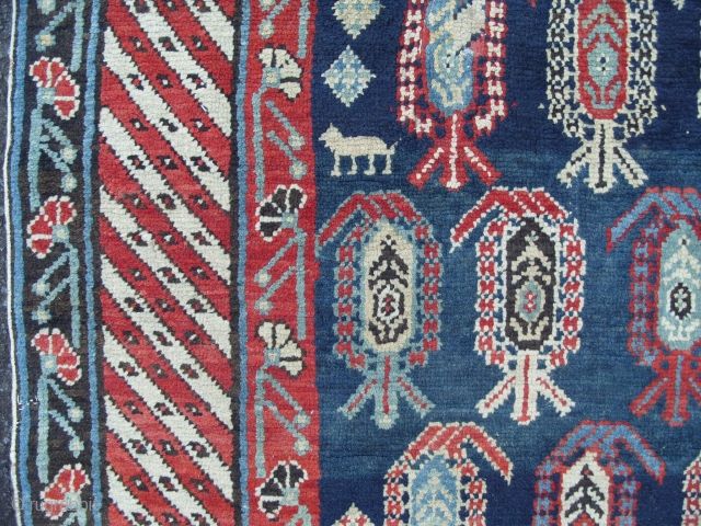 A Caucasian Kuba Long Rug with lots of botehs on a beautiful blue ground, ca 1900, very good condition, all original, 108x46 inches (273x116 cm). www.rugspecialist.com       