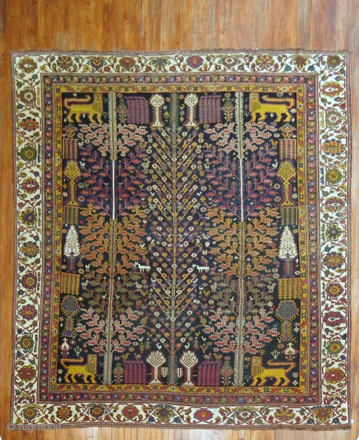 One of a Kind Persian Pictorial Bakhtiari highly decorative Rug on an all-over repetitive on a navy blue ground

Details
rug no.	j1270
size	10' x 11' 3" (305 x 343 cm)

https://jdorientalrugs.com/pictorial-persian-bakhtiari-rug/id/j1270      