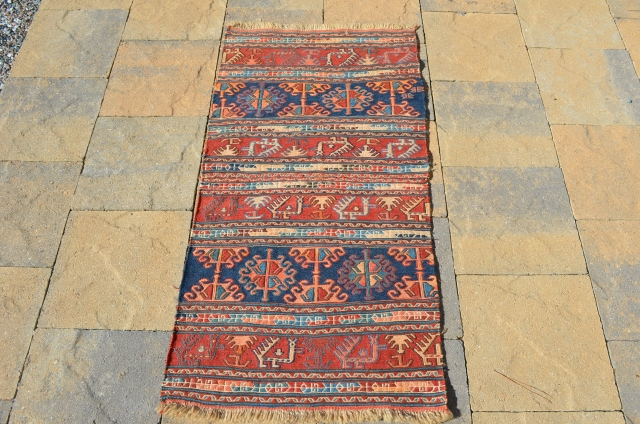 An interesting Soumak mat, actually a pair of bag faces that were put together, each bag measures 23" x 22" making the mat 46" x 22".       