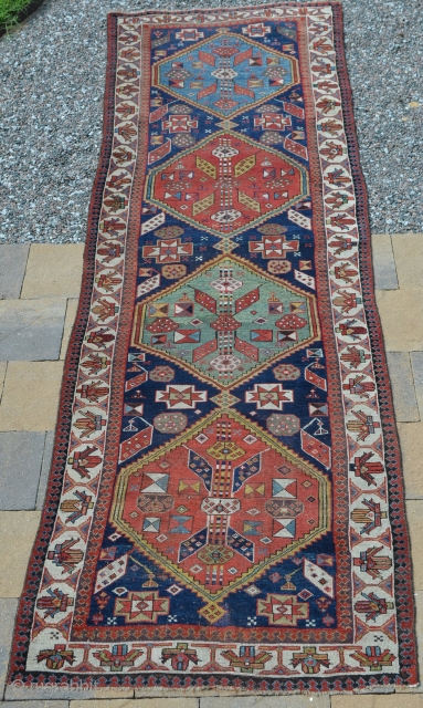 A very nice Northwest Persian runner, late 19th century.  Nice bold colors, age-appropriate wear, low areas.  Note loss to end.  Measures 11'4" x 3'2"      