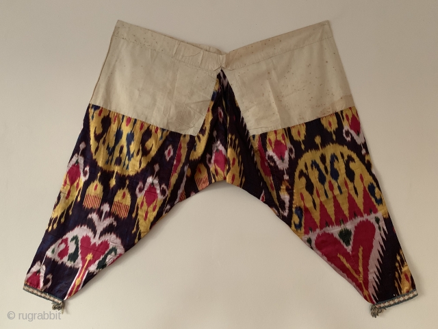 a very rare complete antique Uzbek silk atlas satin weave Ikat trousers dating to the 19th Century. This highly collectible ethnographic garment is attributed to the city of Bukhara. Such silk embroidered  ...