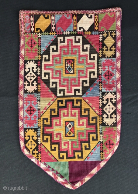 An outstanding example of Antique Uzbek Lakai tribe silk cross stitched shield shaped talismanic hanging known as Uut Kap Ilgich, dating to the 19th century. This is one of the best examples  ...