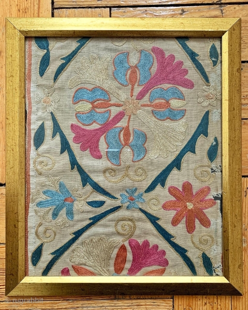 An exceptional antique Uzbek Bukhara silk suzani fragment in a frame with glass dating to early 3rd quarter of the 19th century. The silk chain-stitched embroidery on a beige Karbos ground is  ...